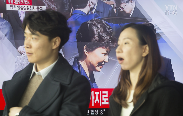 People walk past a TV broadcasting live a news report on former South Korean President Park Geun Hye, at a railroad station in Seoul South Korea Politics, Mar 30, 2017 : People walk past a TV broadcasting live a news report on former South Korean President Park Geun Hye, at a railroad station in Seoul, South Korea. The Seoul Central District Court held a hearing on Thursday to decide whether to issue an arrest warrant for her over corruption allegations that fired her. South Korea s prosecutors filed the request on Monday to detain Park Geun Hye on charges of abuse of authority, coercion, bribery and leaking government secrets, citing the graveness of the alleged crimes and the possibility of the destruction of evidence, local media reported.  Photo by Lee Jae Won AFLO   SOUTH KOREA 