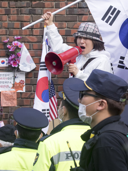 A supporter of former South Korean President Park Geun Hye chants slogans in front of her home in Seoul South Korea Politics, Mar 30, 2017 : A supporter of former South Korean President Park Geun Hye chants slogans in front of her home before she leaves to the Seoul Central District Court in Seoul, South Korea. The court held a hearing on Thursday to decide whether to issue an arrest warrant for her over corruption allegations that fired her. South Korea s prosecutors filed the request on Monday to detain Park Geun Hye on charges of abuse of authority, coercion, bribery and leaking government secrets, citing the graveness of the alleged crimes and the possibility of the destruction of evidence, local media reported.  Photo by Lee Jae Won AFLO   SOUTH KOREA 