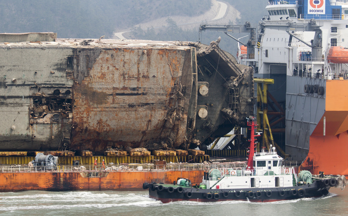 Sunken Sewol Ferry heads to a port in Mokpo Sewol Ferry, Mar 31, 2017 : Semi submersible ship Dockwise White Marlin carries Sewol Ferry to Mokpo New Port in Mokpo, about 311 km  193 miles  south of Seoul, South Korea. The Sewol Ferry sailed into the port on Friday, about three years after it sank off South Korea s southwestern coast near Jindo on April 16, 2014 during a journey from Incheon to Jeju. The Ferry was carrying 475 crew and passengers, mostly high school students on a school trip. More than 300 people died and nine are still missing. Authorities will search for the bodies of nine missing and look into the wreck to find cause of the sinking. The Sewol was built in Japan in 1994 and it was decommissioned ship already when South Korea imported it from Japan in late 2012. South Korean government led by at the time President Lee Myung Bak increased the maximum ship age from 20 to 30 years in 2009 as part of a drive to relax regulations, local media reported.  Photo by Lee Jae Won AFLO   SOUTH KOREA 
