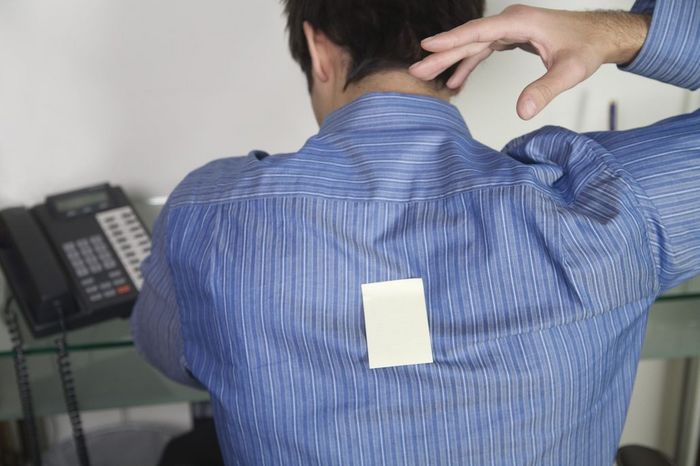 Office Worker with Sticky Note on his Back