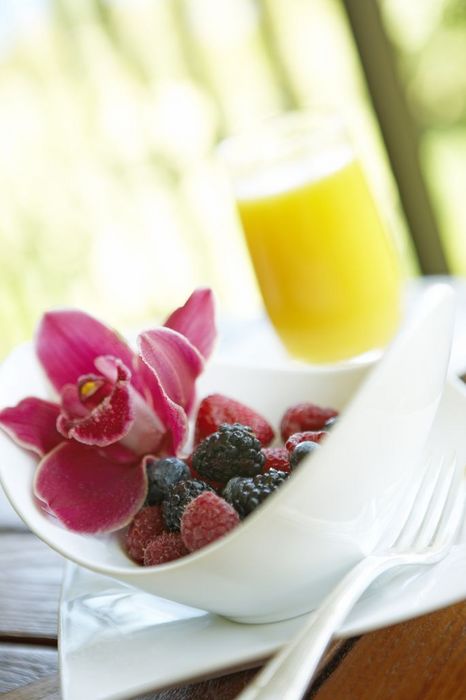 Hawaii, Maui, Balcony, Breakfast fresh Fruit Bowl with orange Juice and Orchid garnish.