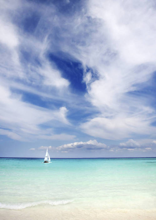 Mexico, Yucatan Peninsula, Sailboat sailing on turquoise water.