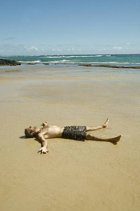 Hawaii, Kauai, South Shore, Male enjoying a day on the beach.
