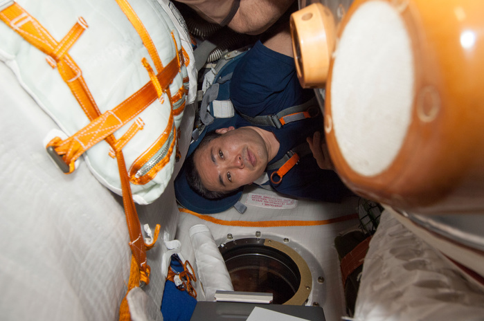 Captain Koichi Wakata, Expedition 39 Crew Member, International Space Station ISS39 E 001422  14 March 2014      Expedition 39 Commander Koichi Wakata of the Japan Aerospace Exploration Agency  JAXA  is photographed during a fit check of the Kazbek couches in the Soyuz TMA 11M spacecraft, which is docked to the International Space Station.