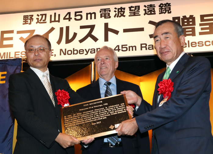 Nobeyama Radio Telescope Recognized as IEEE Milestone June 14, 2017, Tokyo, Japan   National Astronomical Observatory of Japan  NAOJ  Director General Masahiko Hayashi  L  and Mistubishi Electric president Masaki Sakuyama  R  receive a plaque of Institute of Electrical and Electronics Engineers  IEEE  Milestone award from IEEE president elect James Jefferies  C  in Tokyo on Wednesday, June 14, 2017. NAOJ s Nobeyama 45 meters radio telescope has been recognized for an IEEE Milestone as the world s laegest millimeter wave radio telescope to discover a supermassive black hole.  Photo by Yoshio Tsunoda AFLO  LwX  ytd