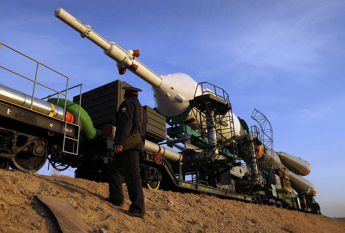The Soyuz TMA-13 spacecraft is transported by railcar to its launch pad.