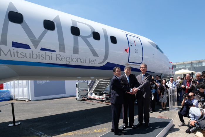 2017 Paris Air Show MRJ actual aircraft on display for the first time  Hisakazu Mizutani  right , Mitsubishi Aircraft Corporation s president, Shunichi Miyanaga  center , Mitsubishi Heavy Industries  President and Chief Executive Officer, and Osamu Shinobe, ANA Holdings Inc. s Vice Chairman, shake hands in front of the third Flight Test Aircraft  FTA 3  of Mitsubishi Regional Jet  MRJ  at the Le Bourget Airport, a day before the opening of the 2017 Paris Air Show on June18, 2017, in Paris, France.  Photo by Yuriko Nakao AFLO 