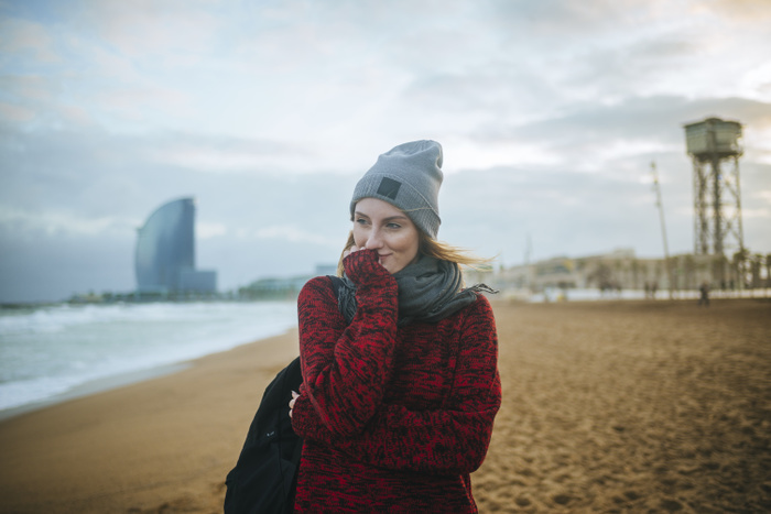 female Spain, Barcelona, young woman on the beach in winter
