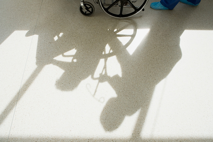 Nurse pushing patient in wheelchair Nurse pushing patient in wheelchair