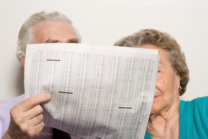 Elderly couple with newspaper Elderly couple with newspaper