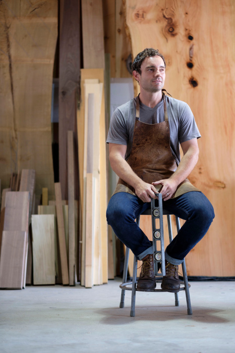   Carpenter at his workshop, holding woodwork tool