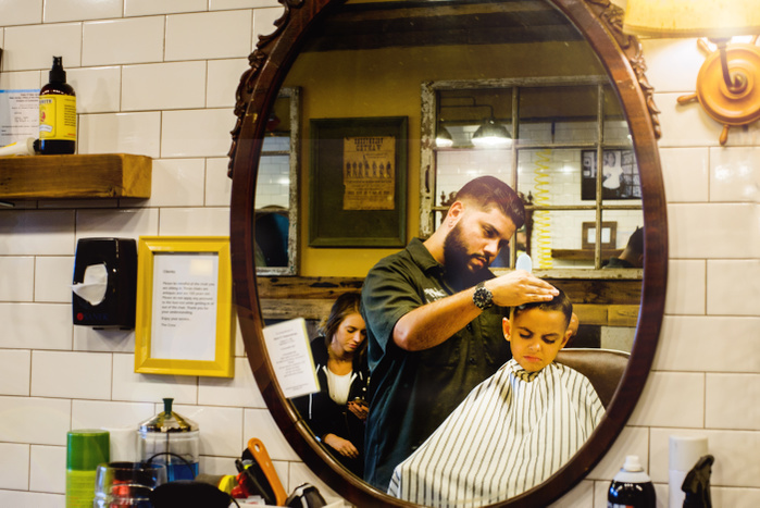   Barber shaving boy s hair