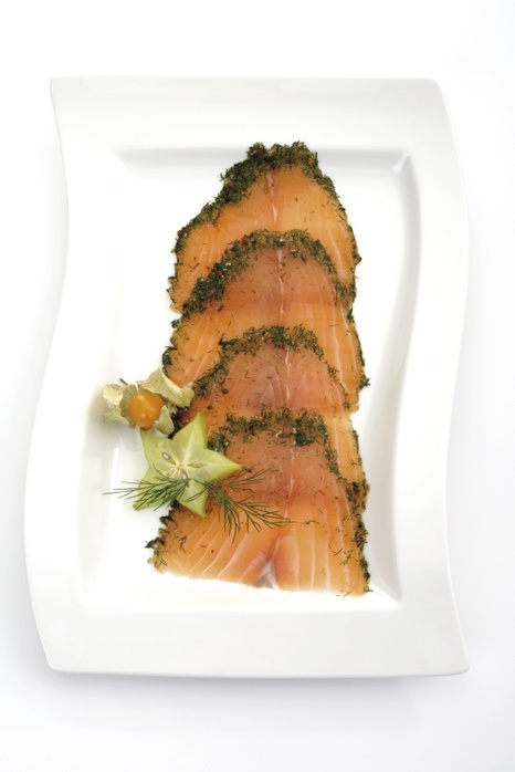   Sliced salmon  gravlax  garnished with starfruit and groundcherries  Physalis 