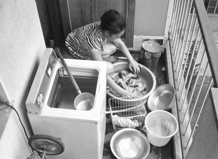 Tokyo Water Shortage Tokyo Water Shortage  1964  Woman washing clothes by hand with water left over from a washing machine, which uses a lot of water. In the summer of 1964, Tokyo was facing a serious water shortage. The expected rainfall for Tokyo s water sources was 407 mm in May, June, and July, but the actual rainfall was 261 mm, 50 percent of the normal. A  rain making  ceremony was held at the Ogouchi Shrine upstream of the Tama River, and a fourth limit of five hours of water supply per day was put in place on August 6. If the 200 water trucks of the Self Defense Forces became the only source of water, some households dug wells at a cost of 200,000 yen. The drought of the Tokyo Olympics and the  Tokyo Desert  became known as the  drought of the Tokyo Olympics. A woman washes her clothes by hand using water that has been left in the washing machine because the machine uses a lot of water. Water is stored in the washing machine   Photographed by a member of the Publication Photography Department in Tokyo in August 1964  1964 .