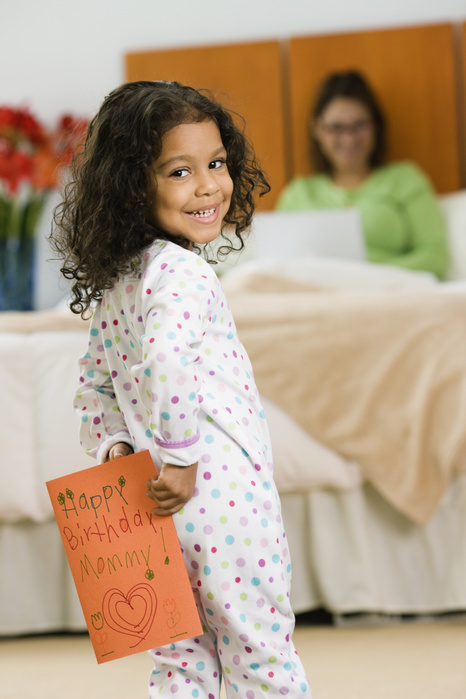Hispanic girl with birthday card for mother