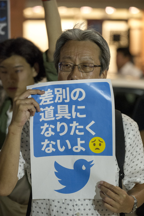 170908 4608   Protest against Hate Speech on Twitter A man holds a message about discrimination at a protest against hate speech on Twitter in front of Twitter Japan headquarters in Tokyo on Friday evening September 8, 2017. The protest was organized by Tokyo No Hate, a loose group of activists who have fought hate and racism in Japan over the past few years. Copies of hateful tweets were laid out on the street. Several speakers expressed their love for Twitter as a communication tool, and their disappointment that Twitter doesn t take down more hate messages. Photo by DUITS AFLO