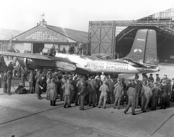 The Reynolds Bombershell, a converted A-26 Douglas attack aircraft, being refueled at Yokota Air Base. Milton Reynolds (white hat in the center) arrived at the base at 7:01 p.m. on April 15, en route to setting a round-the-world flight record. After a short rest, he took off on the final leg of his flight at 9:20 p.m. April 15, 1947 (Photo by Kingendai Photo Library/AFLO)[2373].