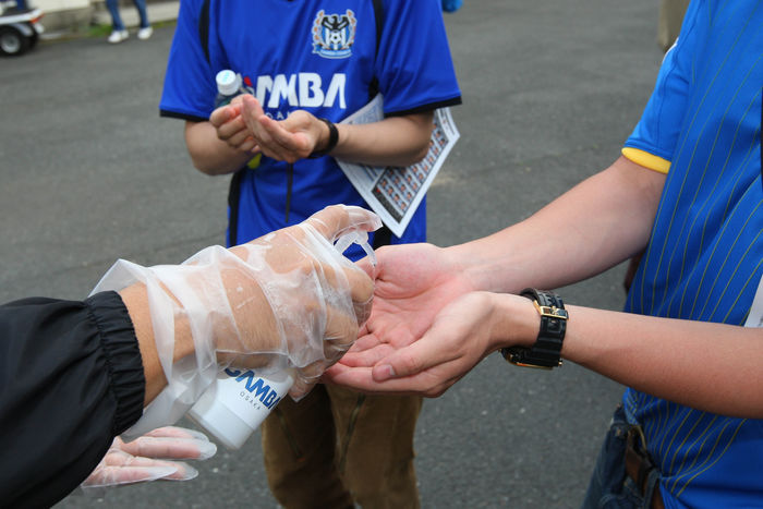 Japanese soccer fans have their hands disinfected before entering a stadium in Osaka, western Japan, for an AFC Champions League match South Korean team edged Japan in a 2-1 narrow victory in Group F. (Photo by AFLO SPORT) [1045].