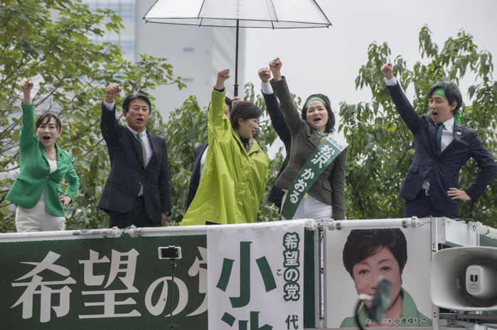 171021 5889   Tokyo Governor Yuriko Koike Tokyo Governor Yuriko Koike  in green raincoat  speaks to support a candidate of her Party of Hope on October 21, 2017 at Shinjuku Station in Tokyo, Japan. This was one of Koike s last street speeches for Japan s Lower House elections of October 22. Koike was repeatedly distracted during the rally and even forgot to shake hands with the candidate. Photo by DUITS AFLO