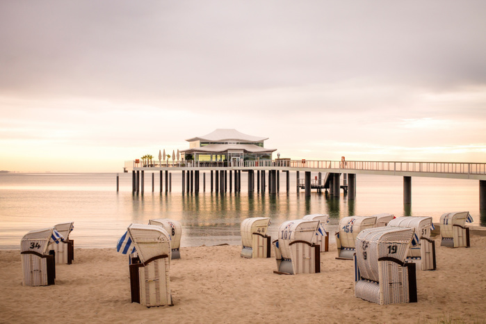 Germany, Niendorf, view to Timmendorfer Strand with hooded beach chairs and sea bridge