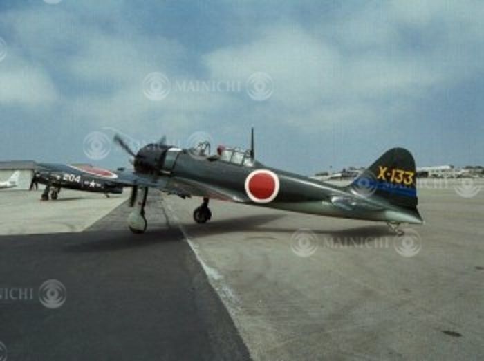 Zero fighter plane flew. Japan and the U.S. cooperated to restore the plane  the late Mr. Kurama and others funded the restoration. The restored Zero Fighter, after its public flight, photographed by Hiroyuki Yoshida on June 15, 1998.