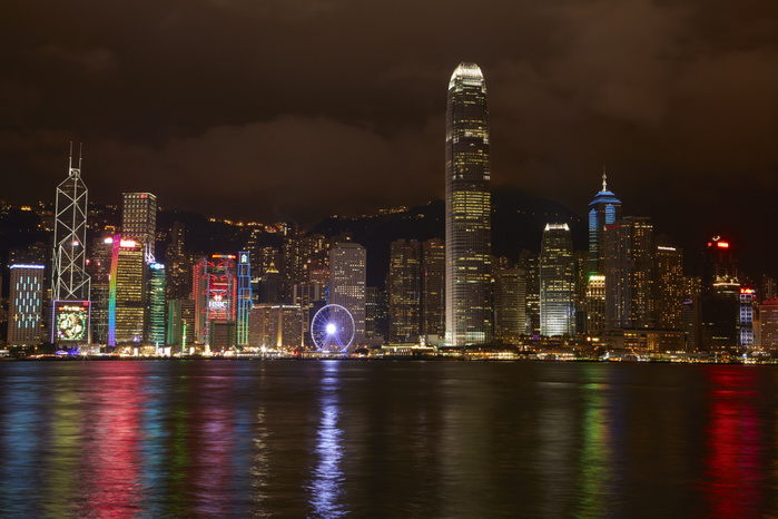 Victoria Harbour, Hong Kong, China Light show on skyscrapers and Hong Kong Observation Wheel, reflected in Victoria Harbour, Central, Hong Kong Island, Hong Kong, China