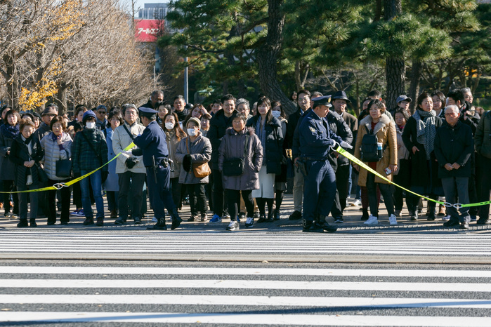 People enjoy the autumn foliage season at the Imperial Palace Tokyo Metropolitan Police restraints visitors access to the Imperial Palace on December 9, 2017, Tokyo, Japan. The Imperial Palace opens its doors to the public twice a year during cherry blossom and autumn foliage season. According to The Imperial Household Agency, around 21,000 people visited the 750 meter road from Sakashita Gate to Inui Gate during its first day of opening on December 2nd. Inui Street remains open to the public until December 10.  Photo by Rodrigo Reyes Marin AFLO 