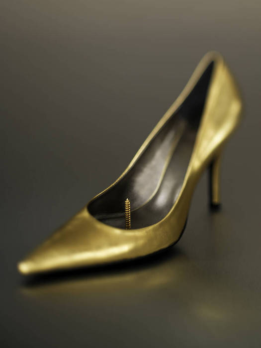 Gold High Heel Shoe with a Large Screw Protruding from the Insole