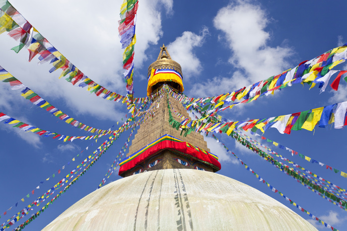 Low angle view of colourful prayer flags on stupa of Buddhist temple. Low angle view of colourful prayer flags on stupa of Buddhist temple.