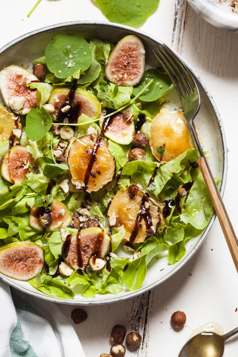 Fig Salad Platter of green salad with figs, Crema di Balsamico, honey hazelnuts and baked goat cheese