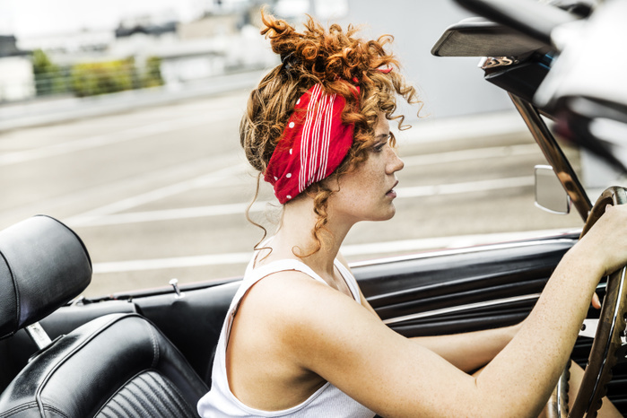 Redheaded woman in sports car