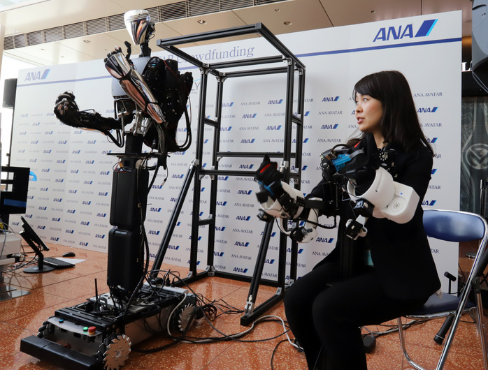 ANA Announces  AVATAR  Business March 29, 2018, Tokyo, Japan   A woman demonstrates Japan s robotics company MELTIN s master slave robot MELTANT alpha as ANA announces that ANA will sponsor the 10 million US dollars  ANA Avator Vision  XPRIZE competition at the Haneda airport in Tokyo on Thursday, March 29, 2018. ANA Avator XPRIZE is a four competition to realize the real world avator technology using robotics, haptics, AR VR and AI to enable humanity to teleport to a remote place.   Photo by Yoshio Tsunoda AFLO  LWX  ytd  
