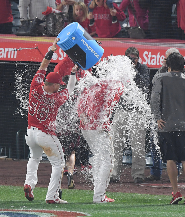 2018 MLB Otani Baptized in Home Field Debut Kole Calhoun  56 of the Los Angeles Angels pours a bucket of ice water on Shohei Ohtani as he is interviewed after the Major League Baseball game against the Cleveland Indians at Angel Stadium in Anaheim, California, United States, April 3, 2018.  Photo by AFLO 
