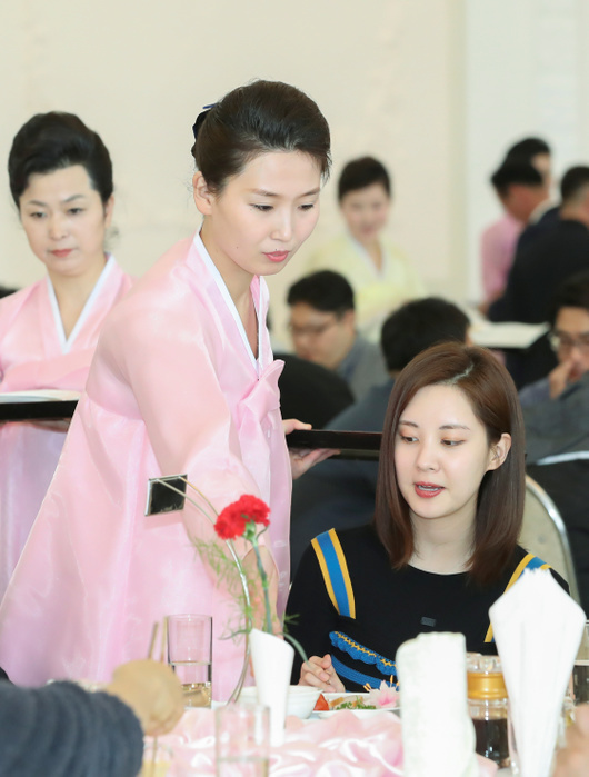 A restaurant employee serves food for Seohyun at Okryukwan Restaurant in Pyongyang Seohyun  Girls  Generation , Apr 2, 2018 : A restaurant employee serves food for Seohyun  R , who was visiting Pyongyang as a member of a South Korean art troupe for performances, at Okryukwan Restaurant in Pyongyang, North Korea. North Korean leader Kim Jong Un is set to hold a summit with South Korean President Moon Jae in in Panmunjom on April 27, 2018 and it will be followed by a meeting with U.S. President Donald Trump in May or June. Picture taken on Apr 2, 2018. EDITORIAL USE ONLY  Photo by South Korean Art Performance Press Corps via Lee Jae Won AFLO   NORTH KOREA 