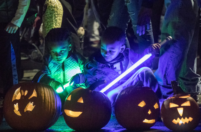 Pumpkin float October 20, 2017,  Frog Pond, Boston Common, Boston, Massachusetts, USA: Nore Douglas  3  and Adrian Rogers  3    L R  admiring pumpkins during the 4th Annual Pumpkin Float at Frog Pond featuring floating pumpkins, luminaries and fun family activities on October 20, 2017.  About 1600 pumpkins are floated according to the organizer.