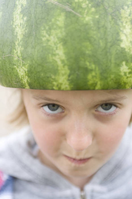 Girl with a helmet made from a watermelon on her head