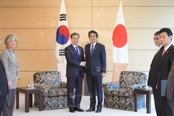 South Korean President Moon Jae in  center left  and Japanese Prime Minister Shinzo Abe  center right  shake hands before their meeting. South Korean President Moon Jae in  center left  and Japanese Prime Minister Shinzo Abe  center right  shake hands before their meeting at the State Guest House in Minato ku, Tokyo, May 9, 2018  Representative Photo 