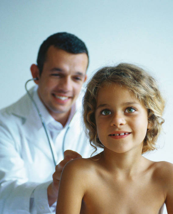 Doctor examining bare chested child with stethoscope