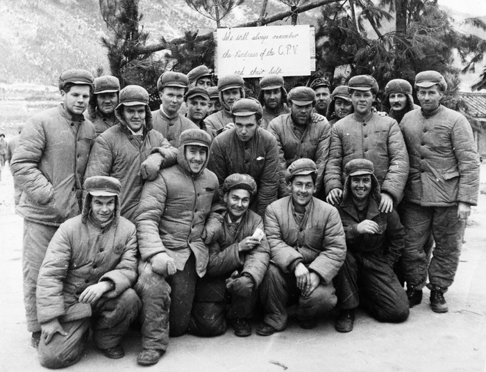 Korean War, U.S. POWs, North Korea  unknown date  Korean War. A happy group of American prisoners in a North Korean POW camp. 1953. The sign behind them reads:  We will always remember the kindness of the C.P.V.  Chinese People s Volunteers  and their help.  