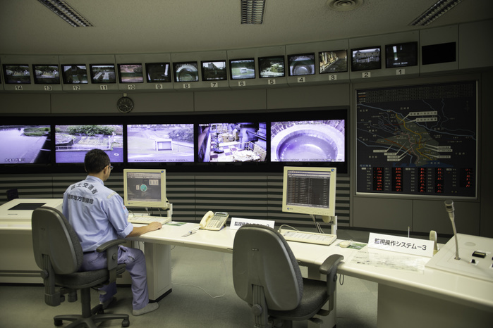 Metropolitan Outer Floodway Management Office  TOKYO, JAPAN   JUNE 20: Yasuyuki Osa, a Subsection Manager sits in front of CCTV screens showing different areas of the facility in the control room of The Tokyo Metropolitan Area Outer Underground Discharge Channel facility in Kasukabe City, Saitama Prefecture, Japan, on Wednesday, June. 20, 2018. The facility, designed to drain flood waters from the surrounding areas after heavy storms or typhoons is used on average seven times a year and has also become a tourist attraction with the facility running guided tours three times a day allowing tourists to visit the massive underground water tank.  Photo: Richard Atrero de Guzman  Aflo  