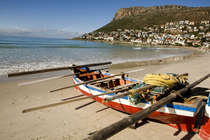 Beautiful Coast of Cape Town = A traditional fishing boat awaits to set sail from Fish Hoek Beach on the False Bay Coast of Cape Town, South Africa on April 15, 2008. The traditional industries of 'trek' fishing and angling coexist with the leisure pursuits of surfing, surfboarding, and angling. The long Fish Hoek beach is one of the safest in the Cape for bathing and body boarding. Cape Town is renown for having some of the best beaches in the world. Situated at the very tip of the vast African continent this city is blessed by two oceans that break on Situated at the very tip of the very tip of the vast African continent this city is blessed by two oceans that break on kilometer after kilometer of coastline; from the warm, welcoming waters of the Indian Ocean to the icy, bracing breakers of the There is something for everyone: beaches that are more suited to family fun, others that provide great waves for surfing and other water sports, beaches that are ideal for surfing and other water sports, beaches that are ideal for family fun. There is something for everyone: beaches that are more suited to family fun, others that provide great waves for surfing and other water sports, beaches that are ideal for sunsets, and others that are perfect for swimming. (Photo by Aurora Photos/AFLO) [2980].