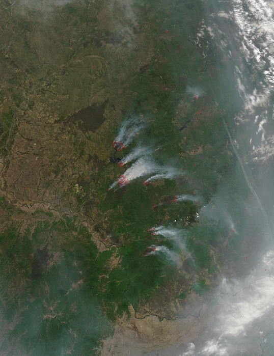 Forest fires in the Russian Far East = Large fires were burning in the forests of Siberia between the Amur River (known as Heilong Jiang in China) and the Bureya River on May 24, 2009, Places where the sensor detected actively burning fires are marked Dark brownish-purple patches on the landscape are burn scars from previous fires. In the eastern part of the image may be from these fires as well as fires farther west, south of Lake Baikal. Both accidental and natural forest fires are common in spring and summer in Russia. (Photo by NASA/AFLO) [3133].