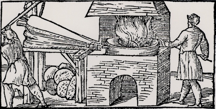 Using bellows to increase the draught in a furnace for refining copper. From 'De la pirotechnia' by Vannoccio Biriguccio (Venice, 1540).  