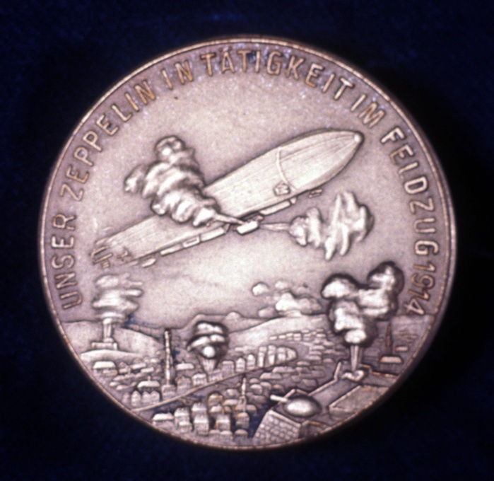 Zeppelin airship in action during World War I. Reverse of medal commemorating Count Ferdinand von Zeppelin (1838-1917), German army officer.