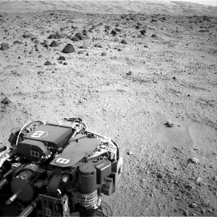 A view of Mars taken by the Mars rover Curiosity  photo provided by NASA  The lower slopes of Mount Sharp appear at the top of this image taken by the right Navigation Camera  Navcam  of NASA s Mars rover Curiosity at the end of a drive of about 135 feet  41 meters  during the 329th Martian day, or sol, of the rover s work on Mars  July 9, 2013 .  That was the third drive by Curiosity since finishing observations at the mission s final science target in the  Glenelg  area east of the rover s landing site. The planned entry point to the lower layers of Mount Sharp, the mission s next major destination, lies about 5 miles  8 kilometers  to the southwest.  The turret of tools at the end of Curiosity s robotic arm is in the foreground, with the rover s rock sampling drill in the lower left corner of the image.  Image credit: NASA JPL Caltech