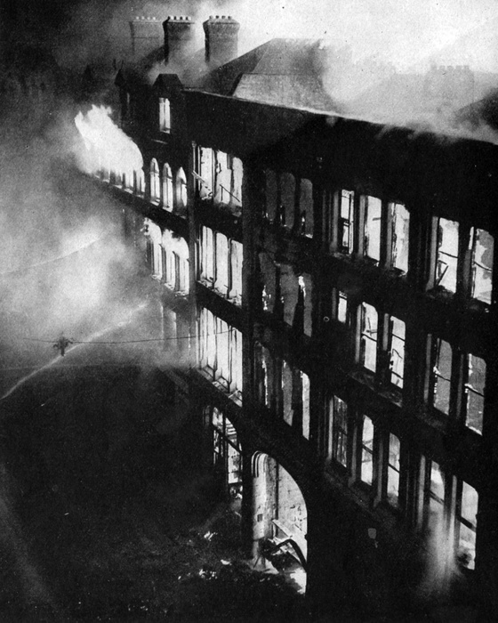 World War II Warehouses in the east of London burning, set alight by bombs dropped from Lufwaffe  German Air Force  planes   during the  Blitz on the night of 24 25 August 1940. London firefighters trying to extinguish flames with hoses. damage.