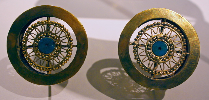 Pair of Earflares.Peru : Sican (Lambayeque) 9-11th century.  Hammered gold, turquoise inlay.  Archaeologists recently excavated a temple platform, where, almost forty feet below they found the tomb of a mighty Sican lord laid to rest with all the trappings of his power and wealth.