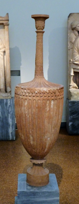 Funerary Lakythos, Pentelic marble, confiscated in Athens.  The neck, mouth, handle and base are restored.  The largest part of the vase is decorated with relief floral motifs and the neck with a scale pattern.  350-325 BC