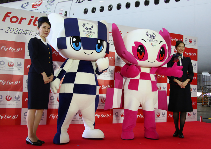 JAL Announces Initiatives for 2020 August 23, 2018, Tokyo, Japan   Tokyo 2020 Olympics mascot Miraitowa  2nd L  and Paralympics mascot Someity  2nd R  smile with Japan Airlines  JAL  cabin attendants in uniforms of third  L  and current generations as JAL president Yuji Akasaka announce sthe business strategy for 2020 at a JAL hangar of the Haneda airport in Tokyo on Thursday, August 23, 2018. JAL will invest 10 billion yen to improve airport facilities and will change their uniforms in 2020.             Photo by Yoshio Tsunoda AFLO  LWX  ytd 