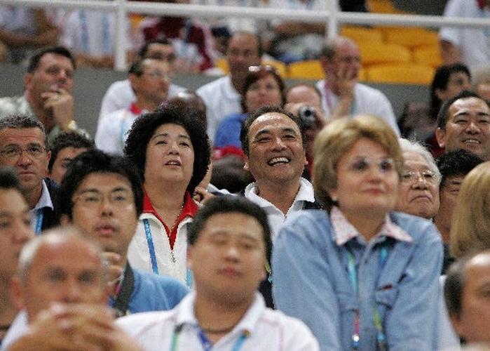 2004 Athens Olympics Gymnastics Men s team final Men s team gymnastics team final at the Athens Olympics. Father and gymnastics team leader Mitsuo  center right  and mother Chieko  center left  smile as they watch Naoya Tsukahara perform on the bars. Photo taken August 16, 2004, at the Indoor Hall of the Athens Olympics General Venue in Athens, Greece.